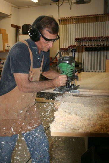 Ron routing a tongue on a maple table